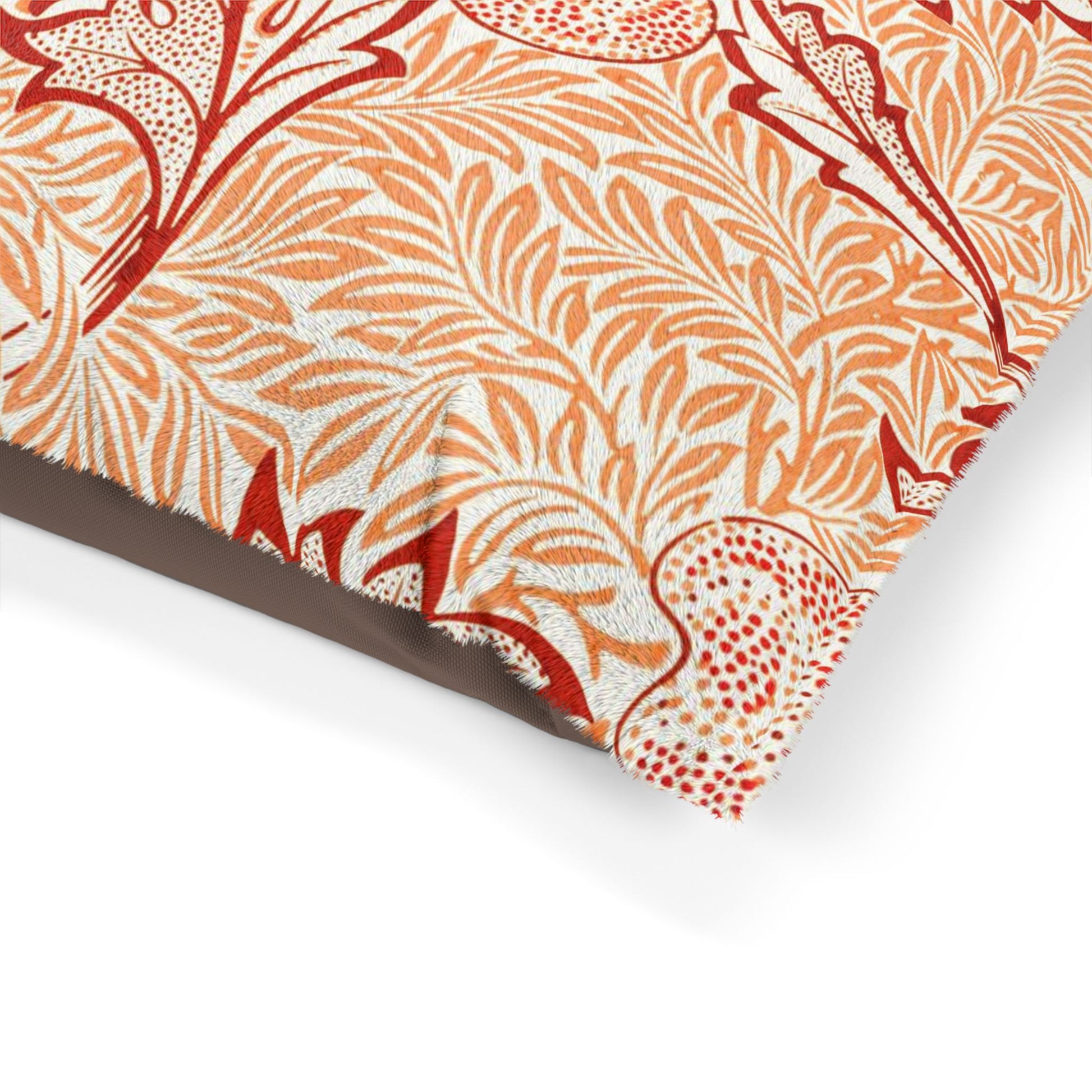 Close-up of a decorative paper with red and orange floral pattern on a white background