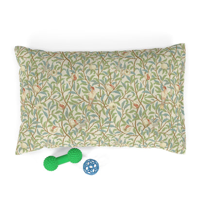 Patterned dog pillow with two dog toys on a white background