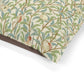 Fabric with a nature-themed William Morris & Co pattern featuring leaves, branches, and birds on a beige background.