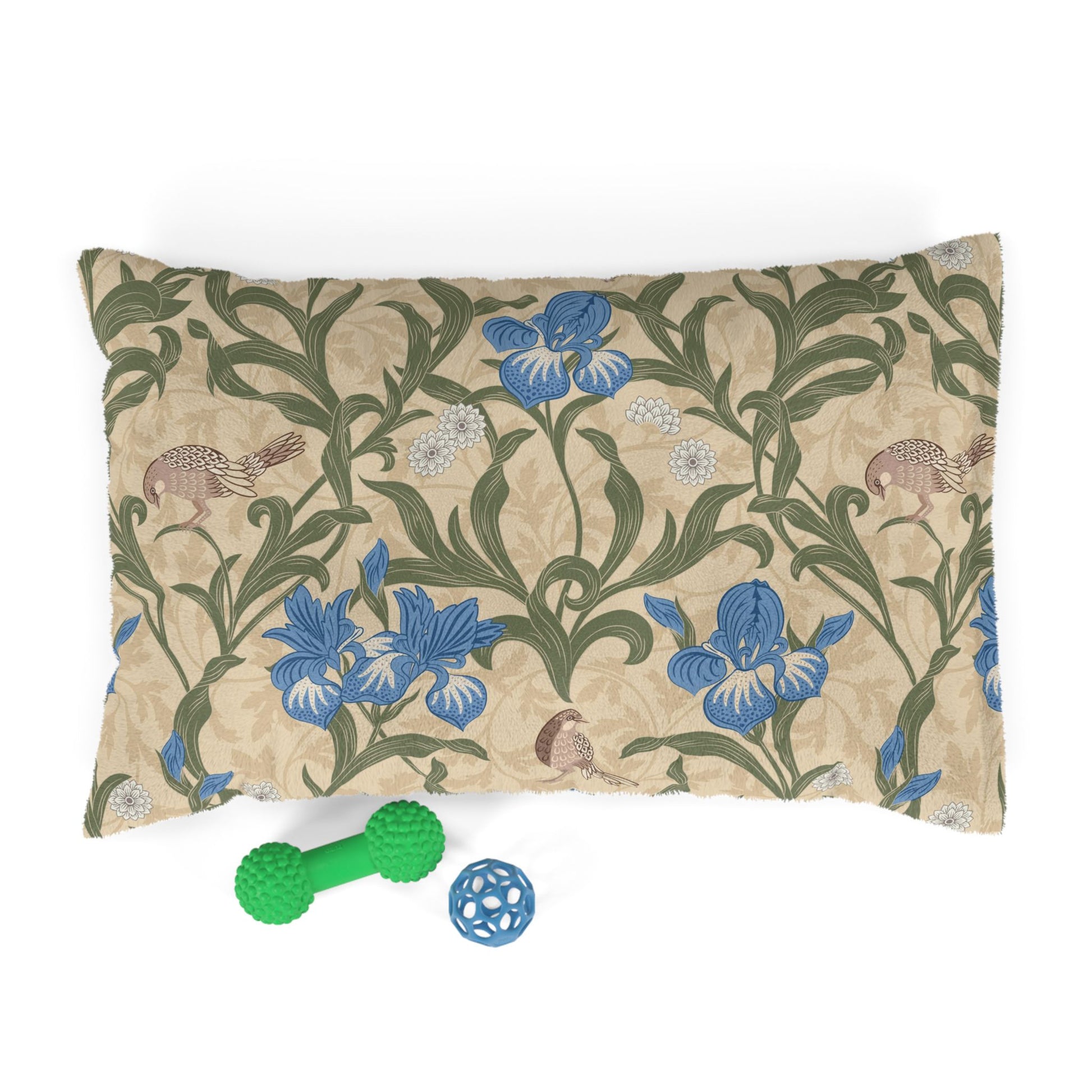 Decorative pillow with William Morris & Co floral pattern and two dog toys on a white background