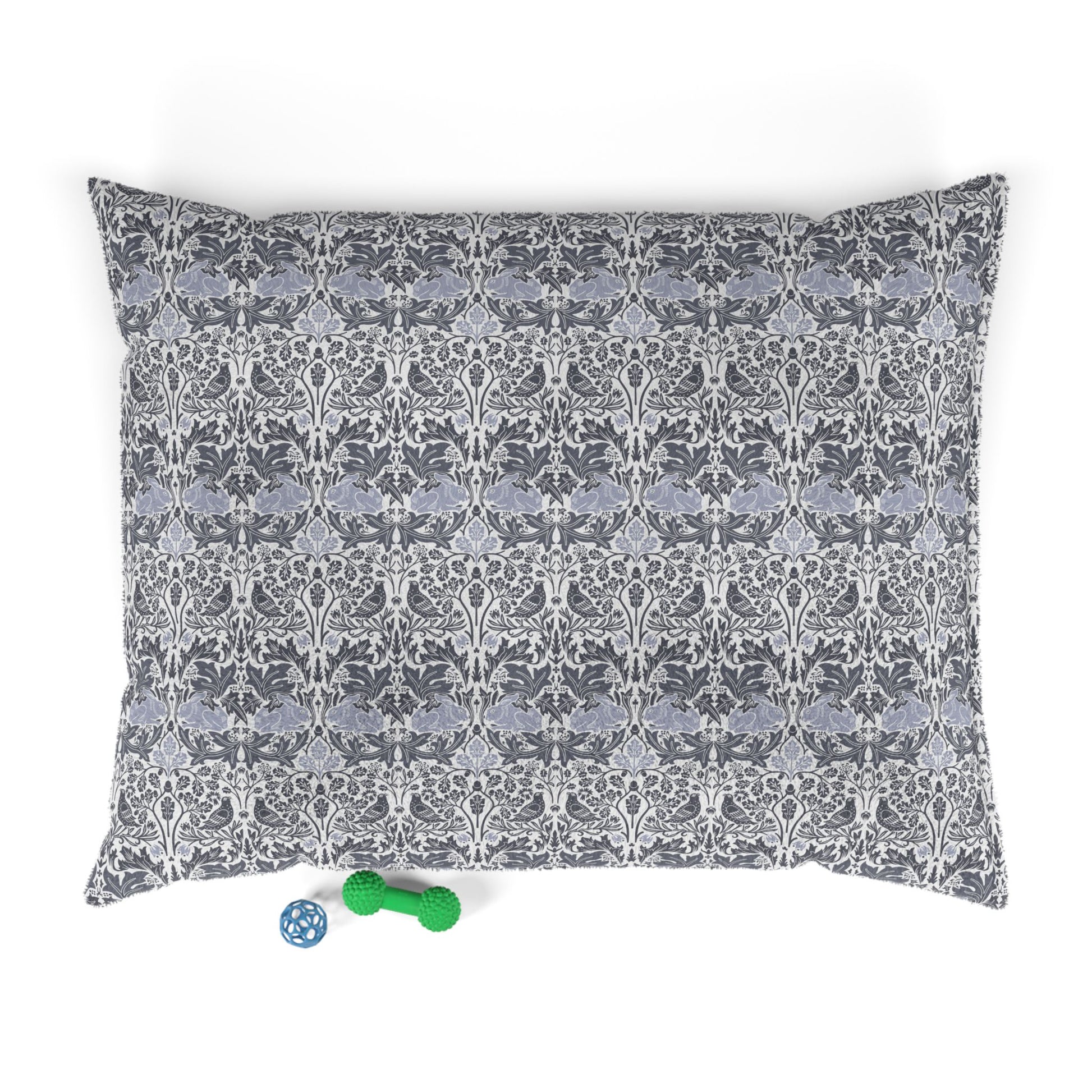 Patterned dog bed pillowcase on a white background with two small toys at the bottom.