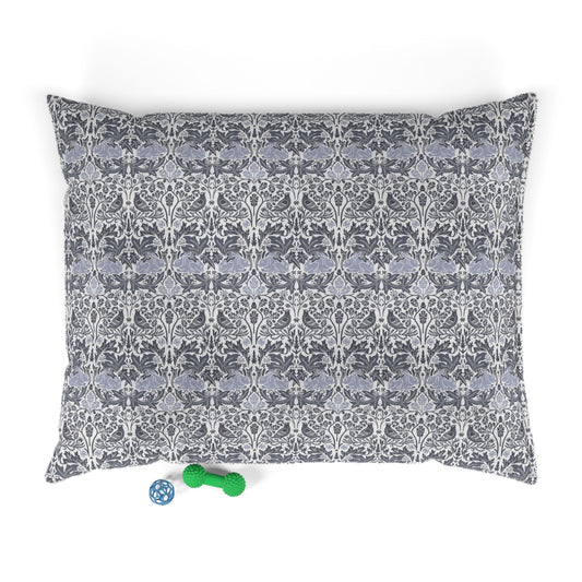 Patterned dog bed pillowcase on a white background with two small toys at the bottom.