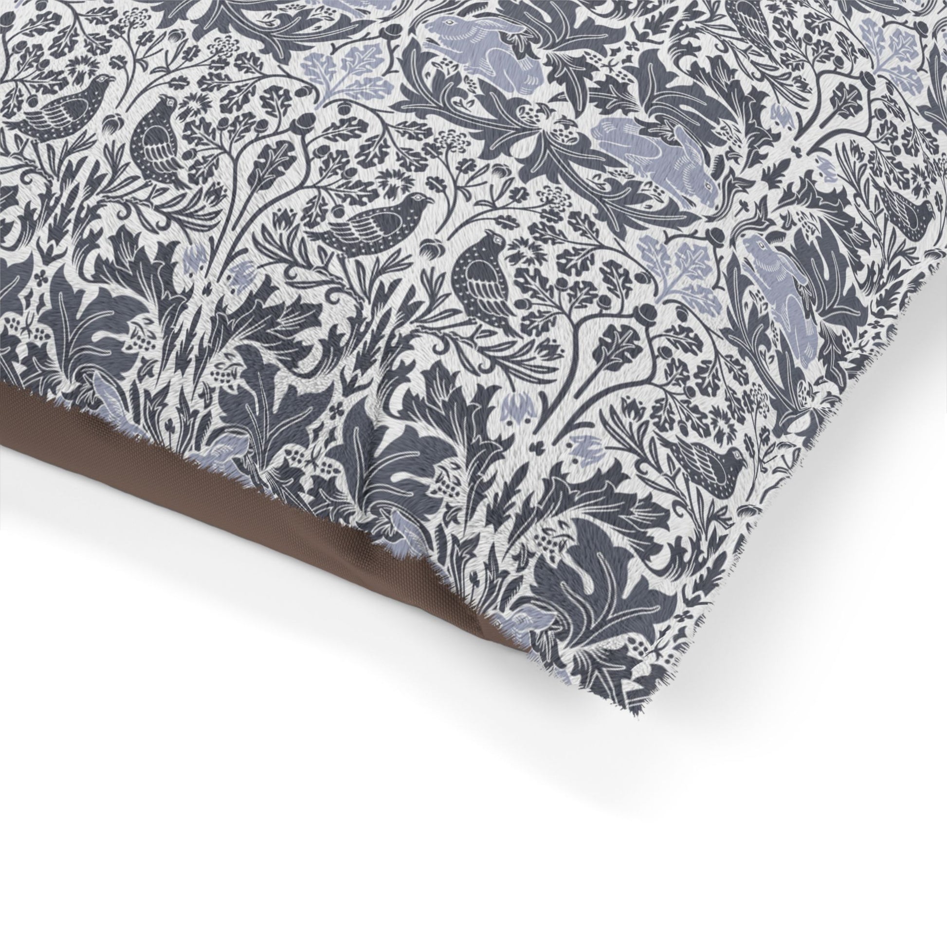 Floral and bird patterned fabric with a brown border on a white background