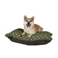 Dog lying on a patterned dog bed with a white background