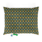 Patterned pillow with yellow flowers on a green background, with a small toy at the bottom.