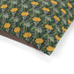 Fabric with a floral pattern featuring yellow flowers and green leaves on a white background