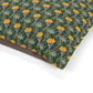 Fabric with a floral pattern featuring yellow flowers and green leaves on a white background