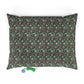 Floral patterned pet bed with two dog toys on a white background