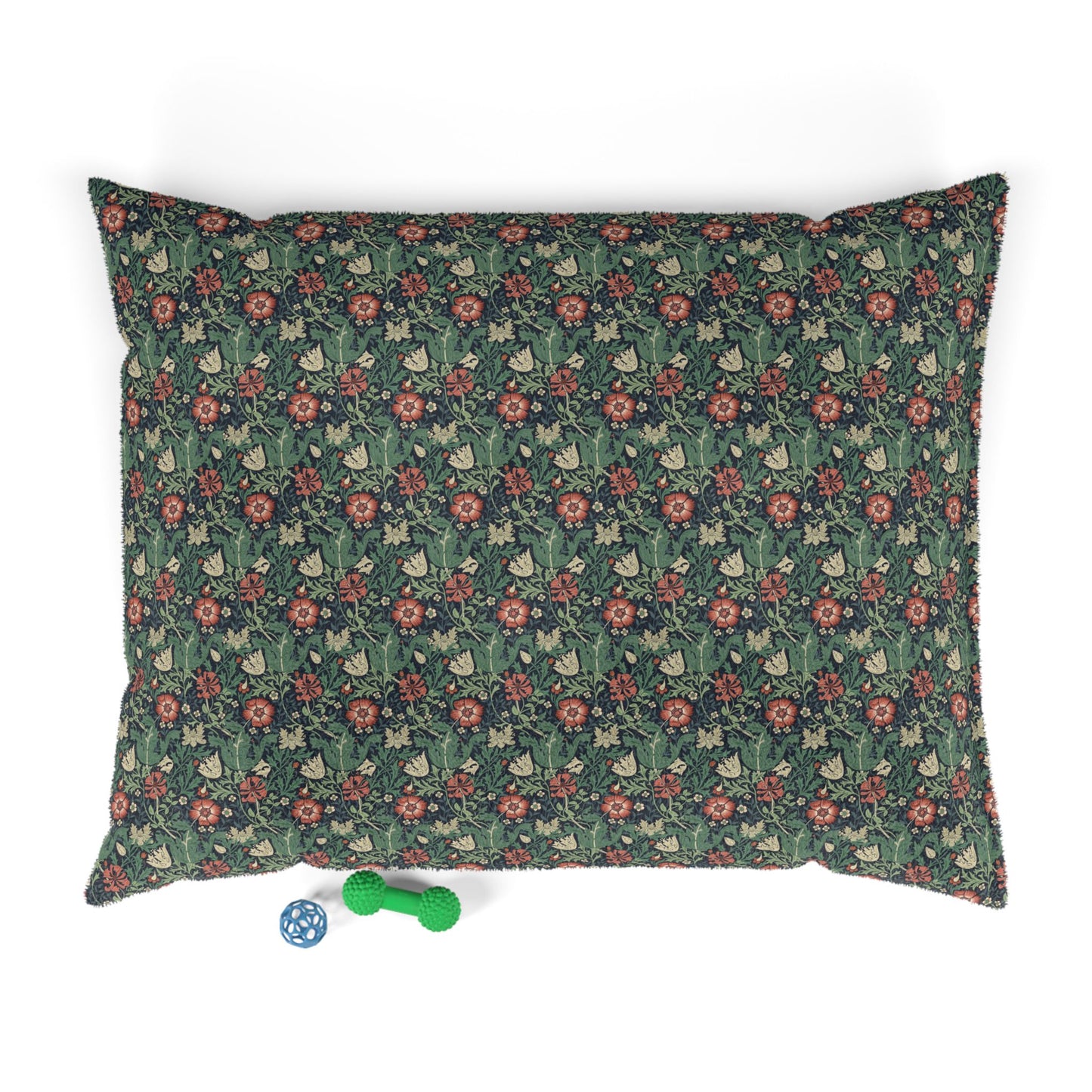 Floral patterned pet bed with two dog toys on a white background