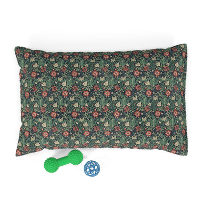 Floral-patterned pillow with two dog toys on a white background