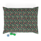 Floral patterned pillowcase on a white background with a green dog toy below.