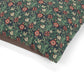 Floral patterned fabric with red, white, and green colors on a white background