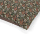 Fabric with a pattern of foxes and flowers on a white background