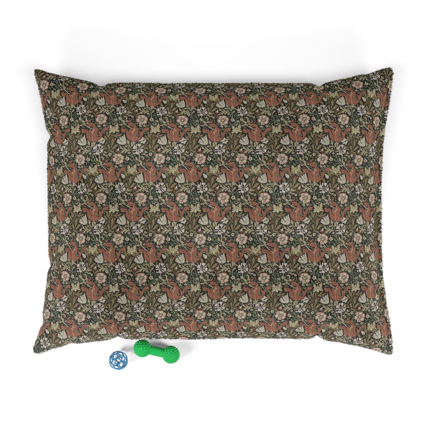 Floral-patterned pillow with small toys on a white background