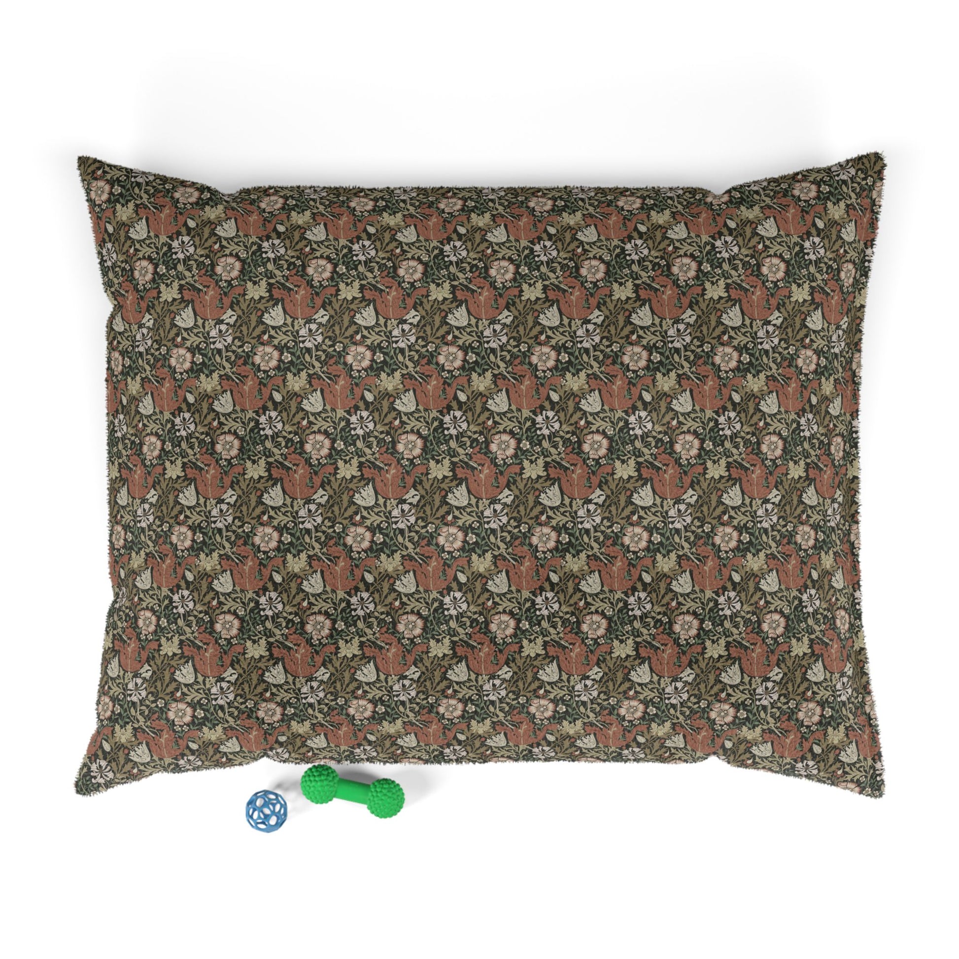 Floral-patterned pillow with small toys on a white background