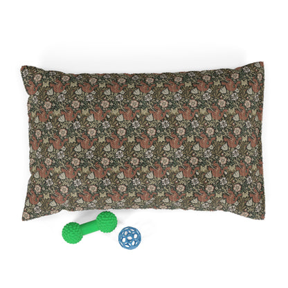 Floral-patterned pillow with two dog toys on a white background