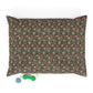 Floral-patterned pillow with two dog toys on a white background