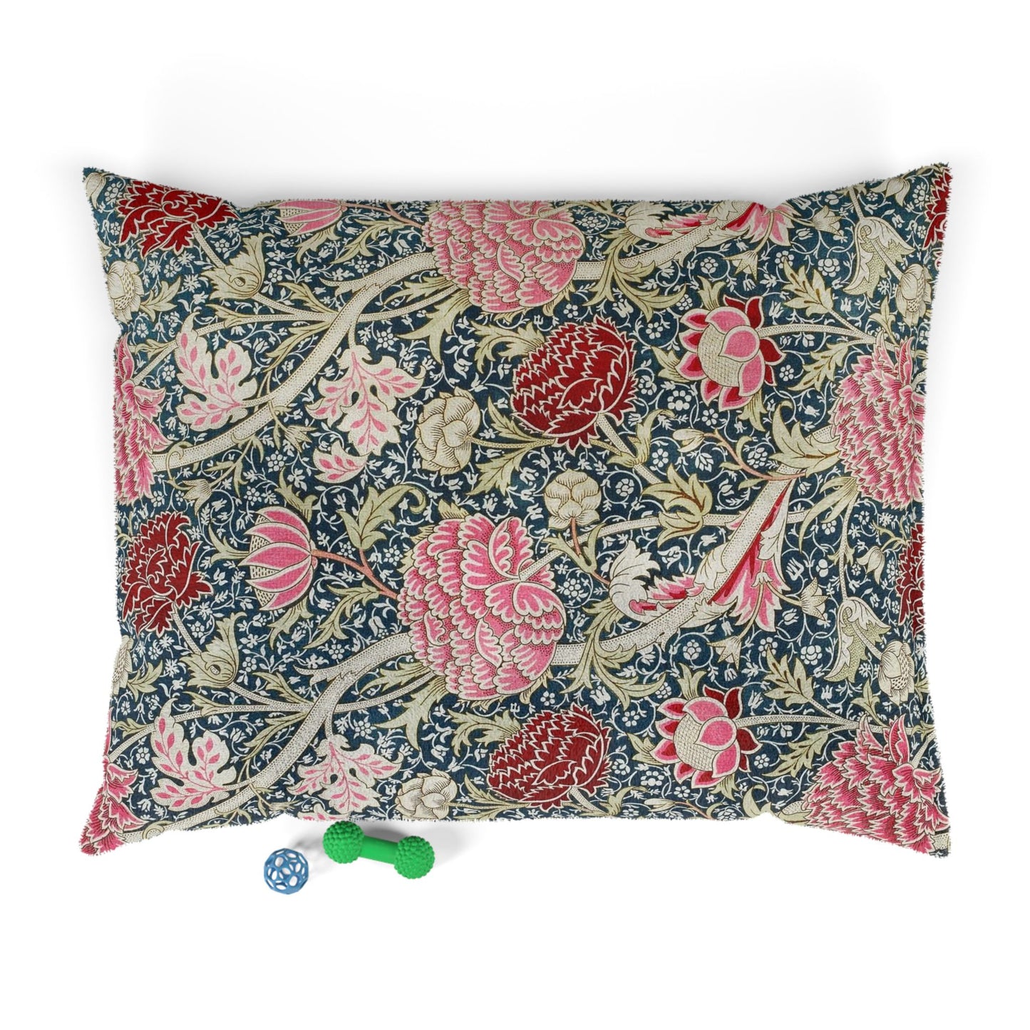 Floral William Morris & Co patterned pillow with two small toys on a white background
