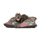 Dog lying on a floral-patterned dog bed with a white background