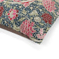 Floral patterned fabric with pink and red flowers on a white background
