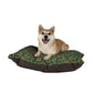 Dog lying on a patterned dog bed with a white background