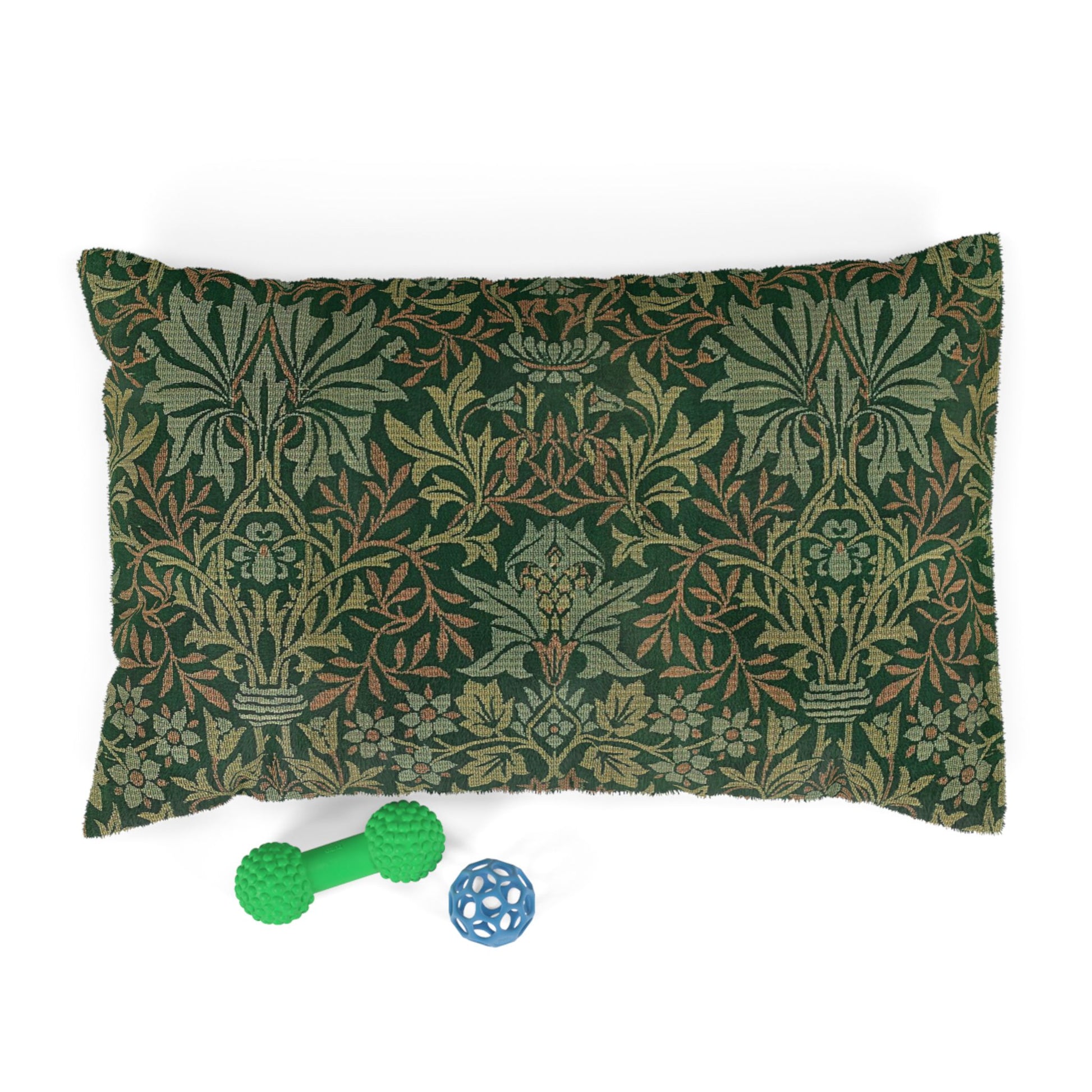 Decorative pillow with a green and brown pattern, accompanied by two dog toys on a white background.