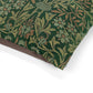 Close-up of a green fabric with a floral pattern on a white background