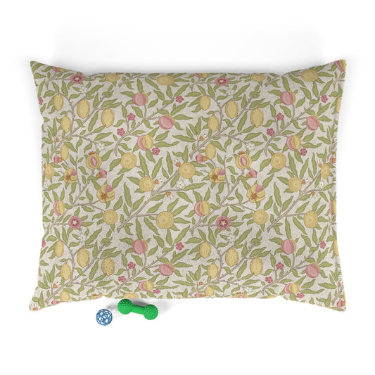 Floral patterned dog bed on a white background with two small toys at the bottom.