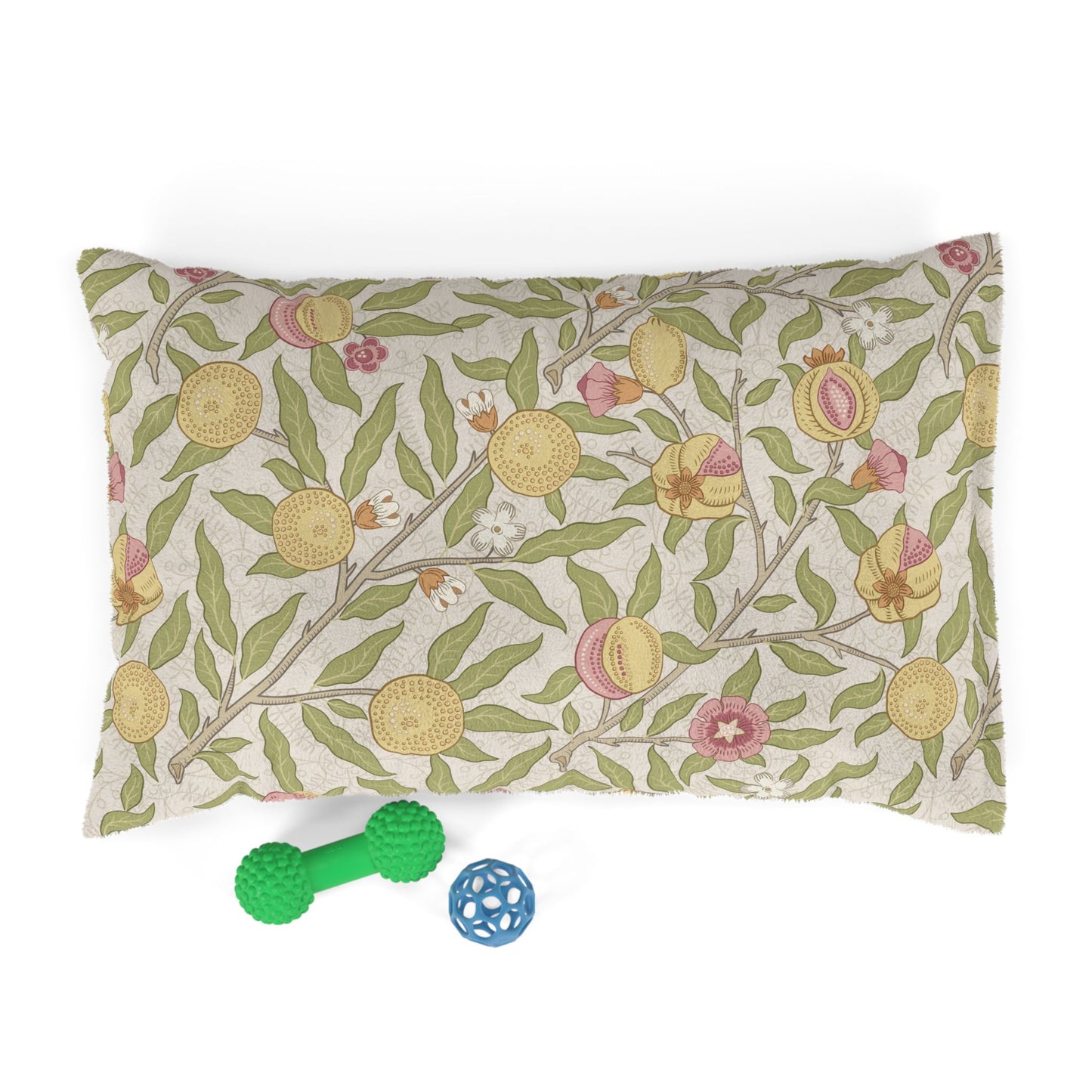 Decorative dog bed pillow with floral pattern and two dog toys on a white background