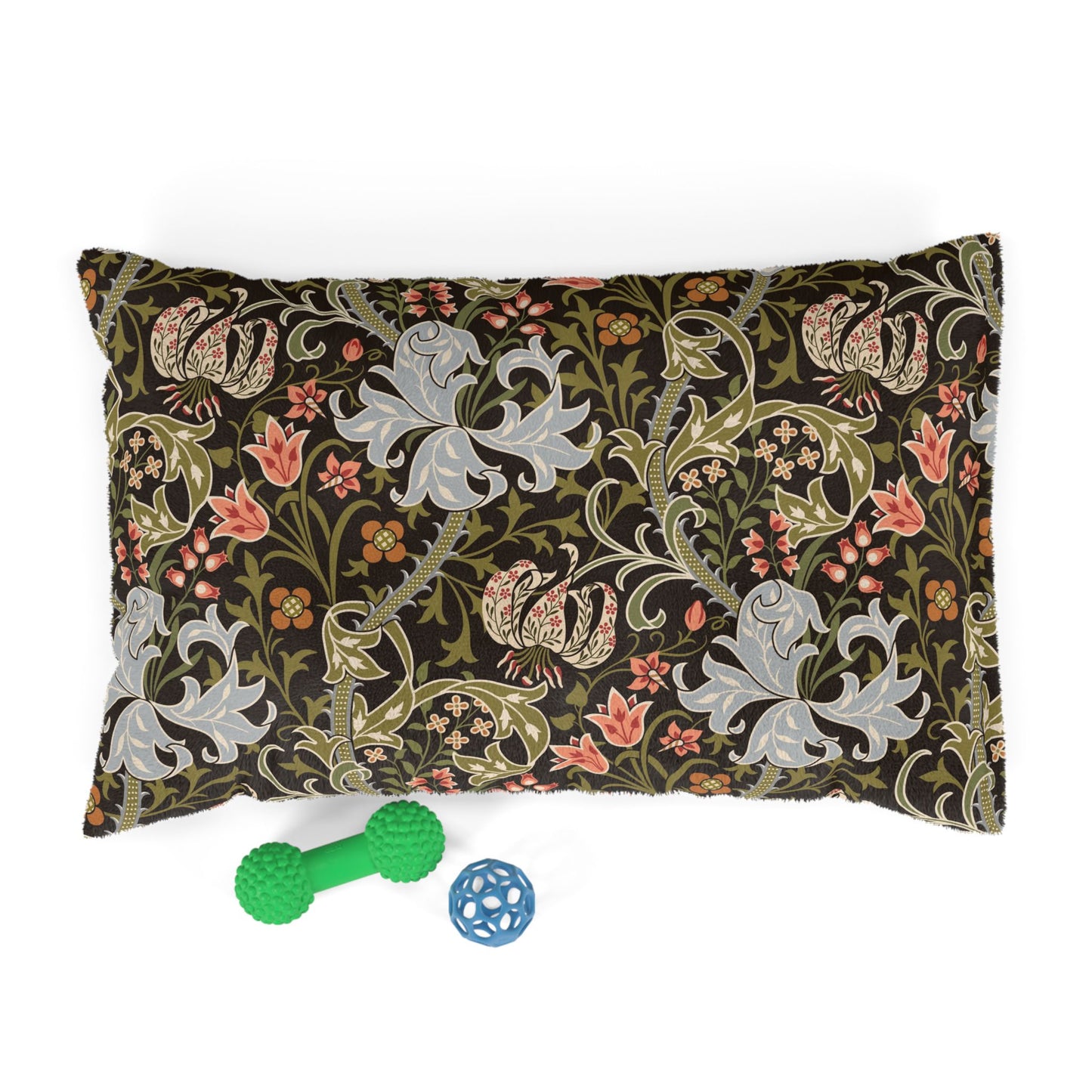 Decorative pillow with floral and dragon pattern next to two dog toys on a white background
