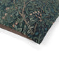 Close-up of a green floral patterned fabric with brown border on a white background