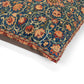 Close-up of a floral patterned fabric with vibrant colors on a white background