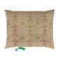 Floral patterned pet bed with two dog toys on a white background