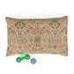 Decorative pillow with floral pattern and two dog toys on a white background