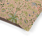 Floral patterned fabric with green leaves and flowers on a pink background