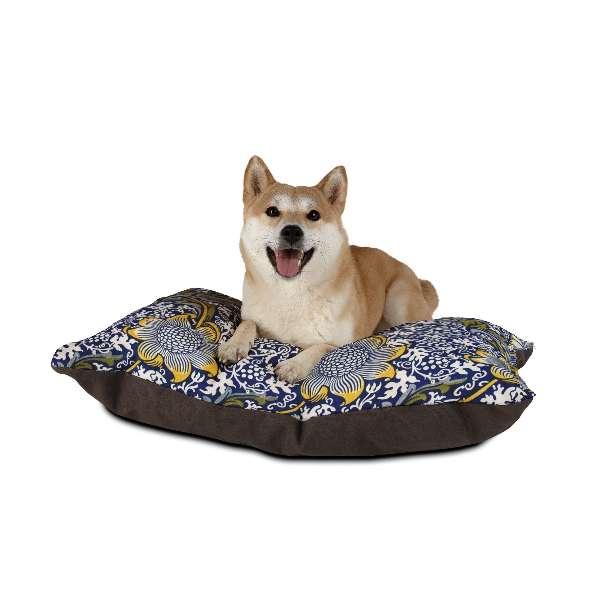 Dog sitting on a floral-patterned pet bed with a white background