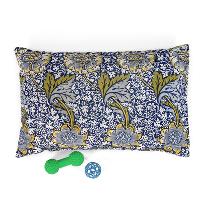 Floral-patterned pet bed with two toys on a white background