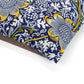 Close-up of a floral patterned fabric with blue, yellow, and white colors on a white background.