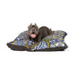 Dog lying on a floral-patterned pet bed with a white background