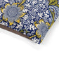 Floral patterned fabric with blue, yellow, and white colors on a white background