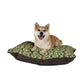 Dog lying on a William Morris & Co floral-patterned dog bed with a white background