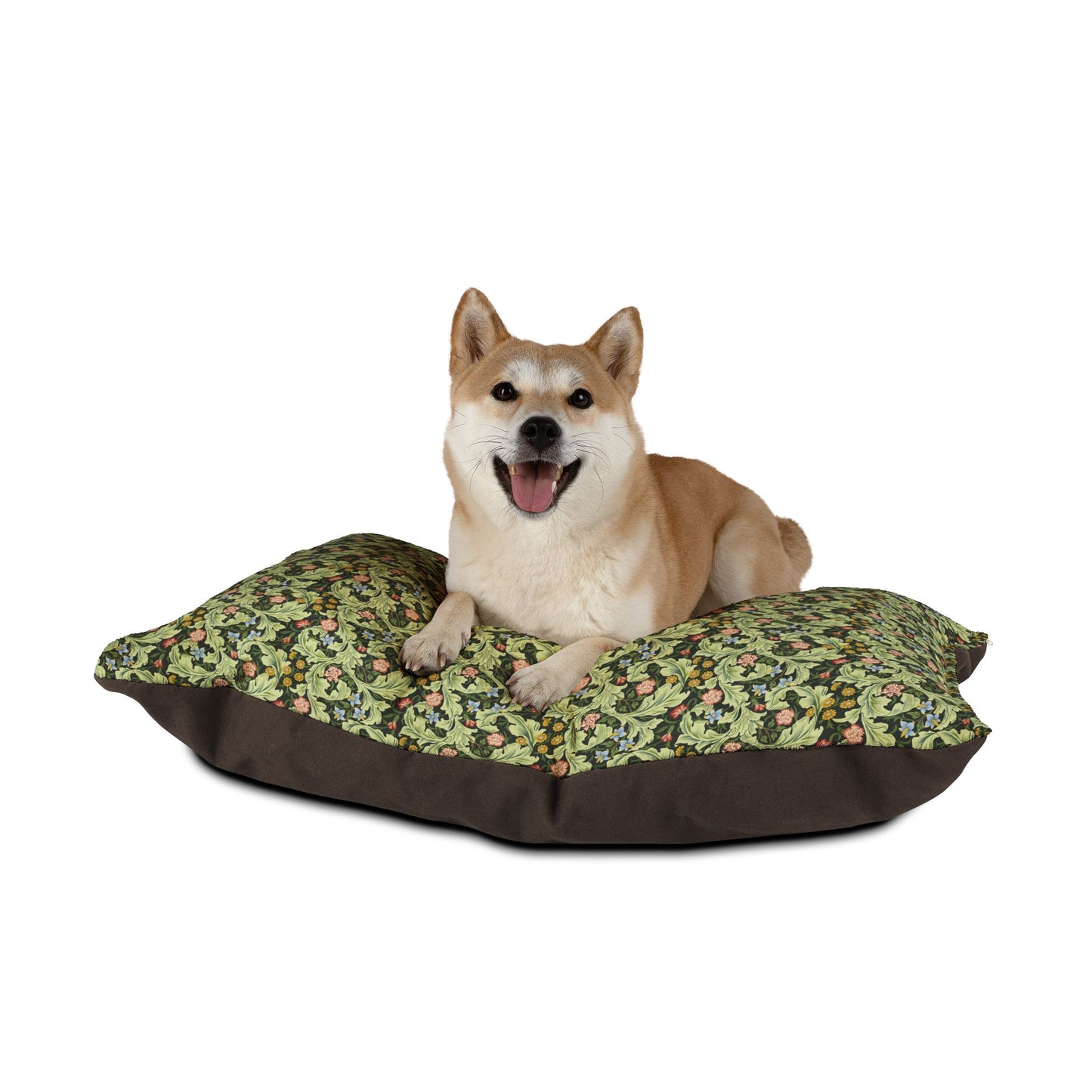 Dog lying on a William Morris & Co floral-patterned dog bed with a white background