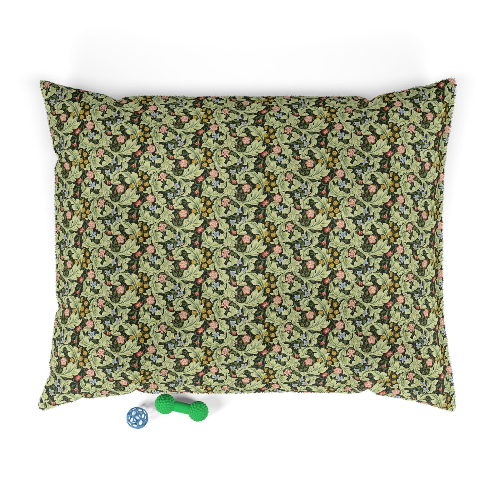 Floral-patterned pet bed with two dog toys on a white background