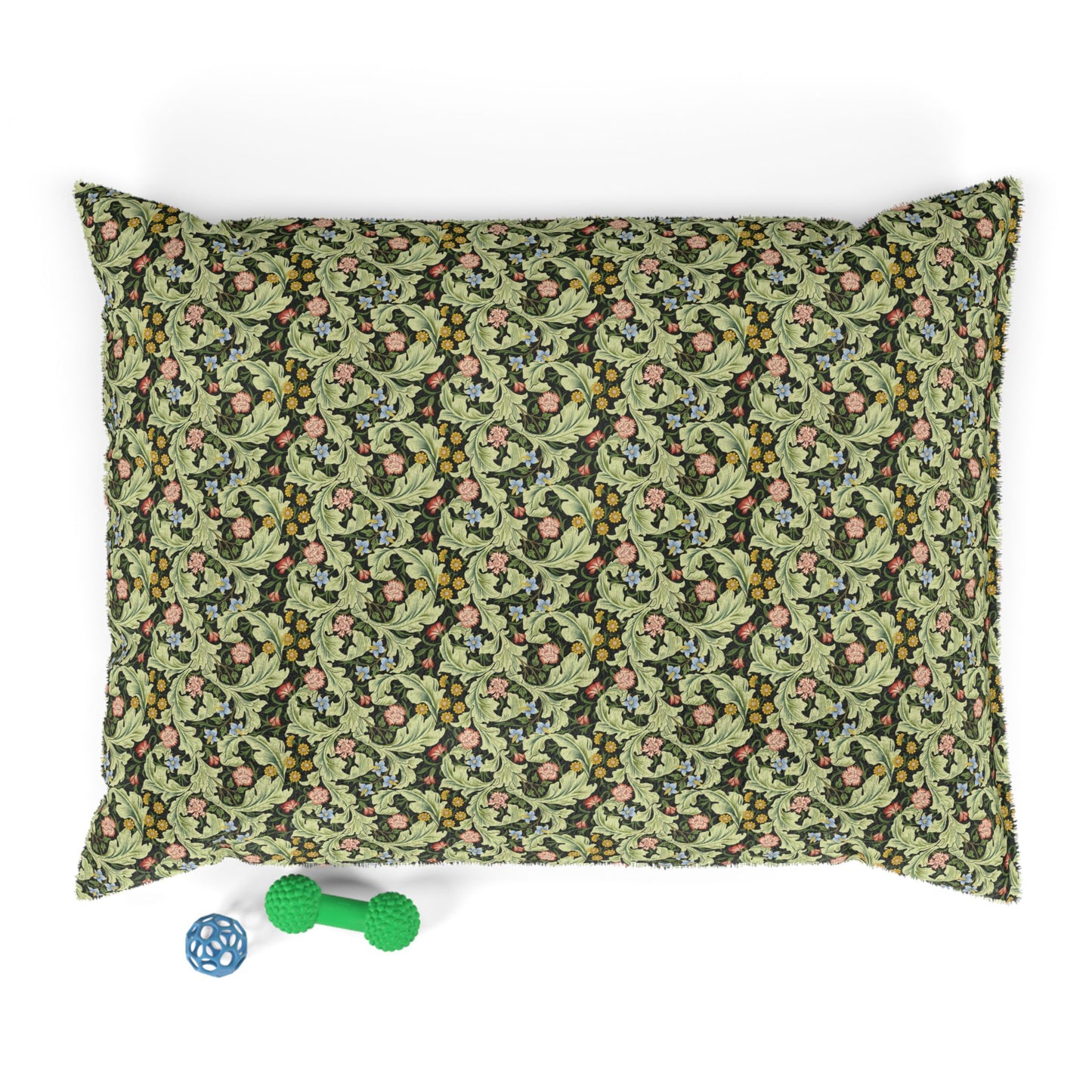 Floral patterned pillowcase on a white background with a green dog toy below.