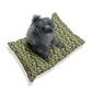 Dog sitting on a floral-patterned cushion with a white background