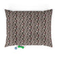 Floral-patterned pet bed with two dog toys on a white background