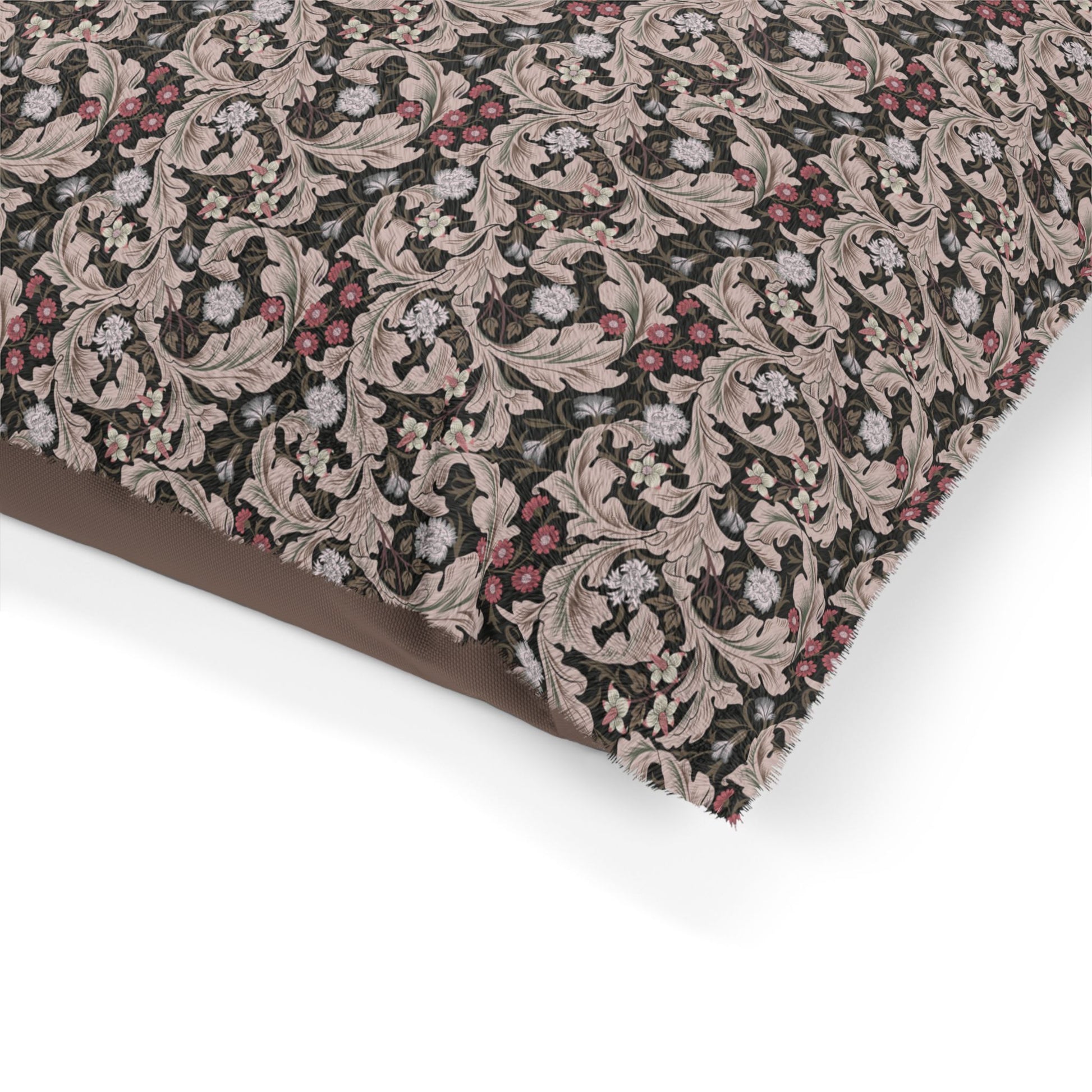 Close-up of a patterned fabric with pink and brown design on a white background
