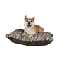 Dog lying on a floral-patterned dog bed with a white background
