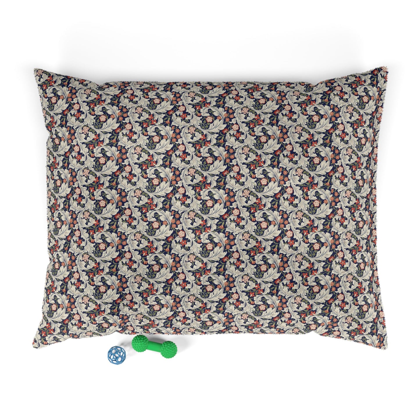 Floral patterned pet bed with two dog toys on a white background