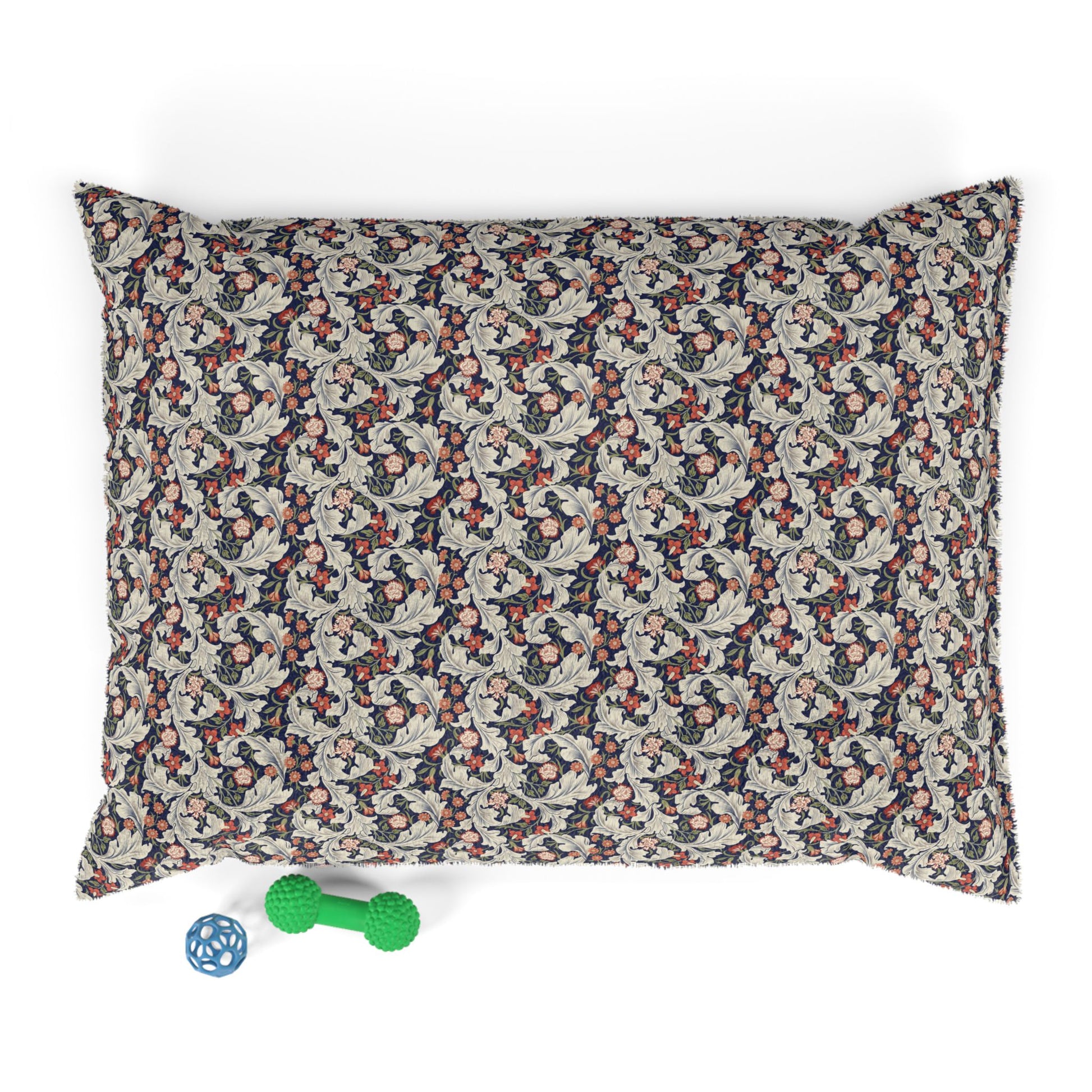 Floral patterned pet bed with small green and blue toys on a white background